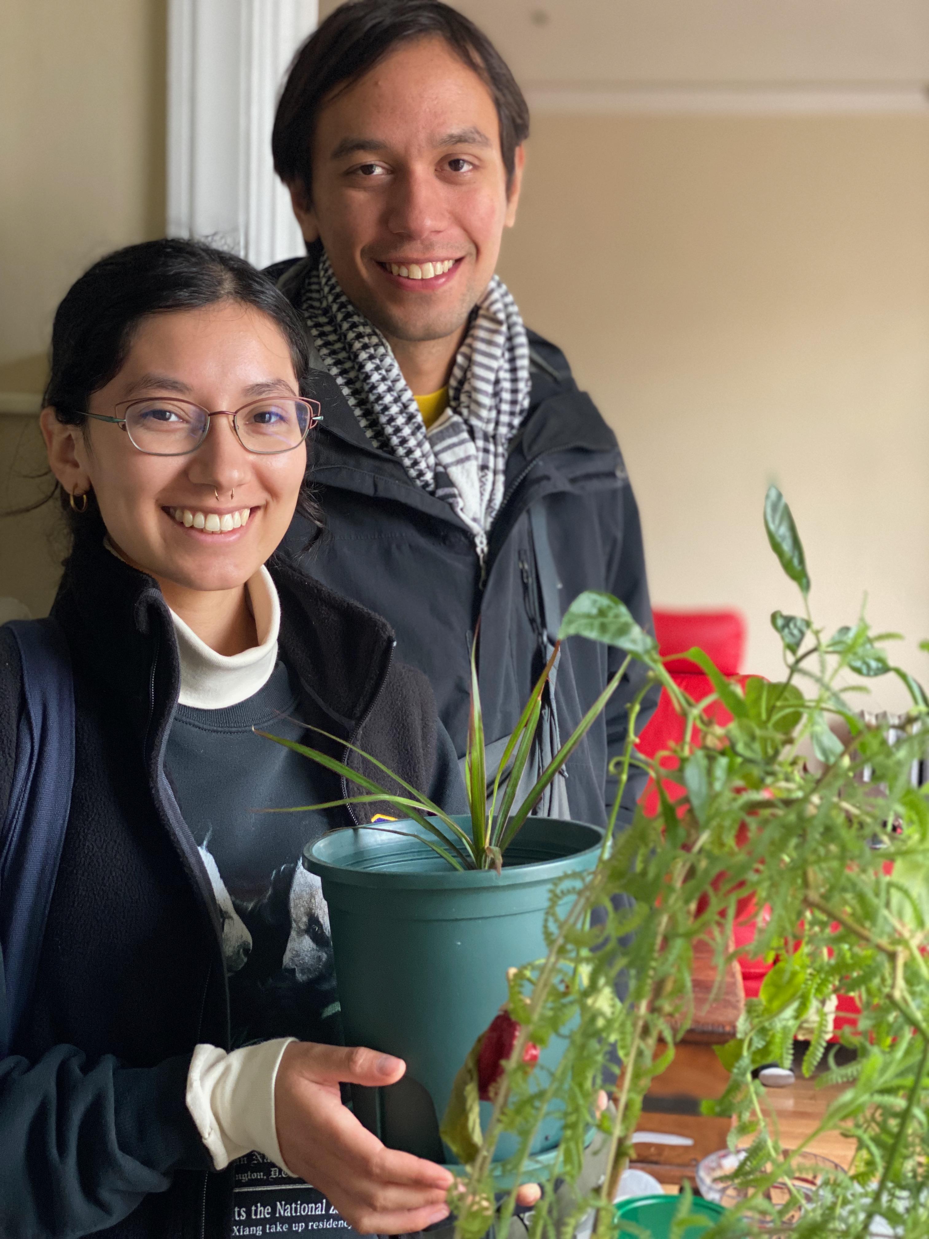 New plant parent smiling while holding a plant gifted by Reza Kaabi from Bank of Trees, ready to start their plant care journey.