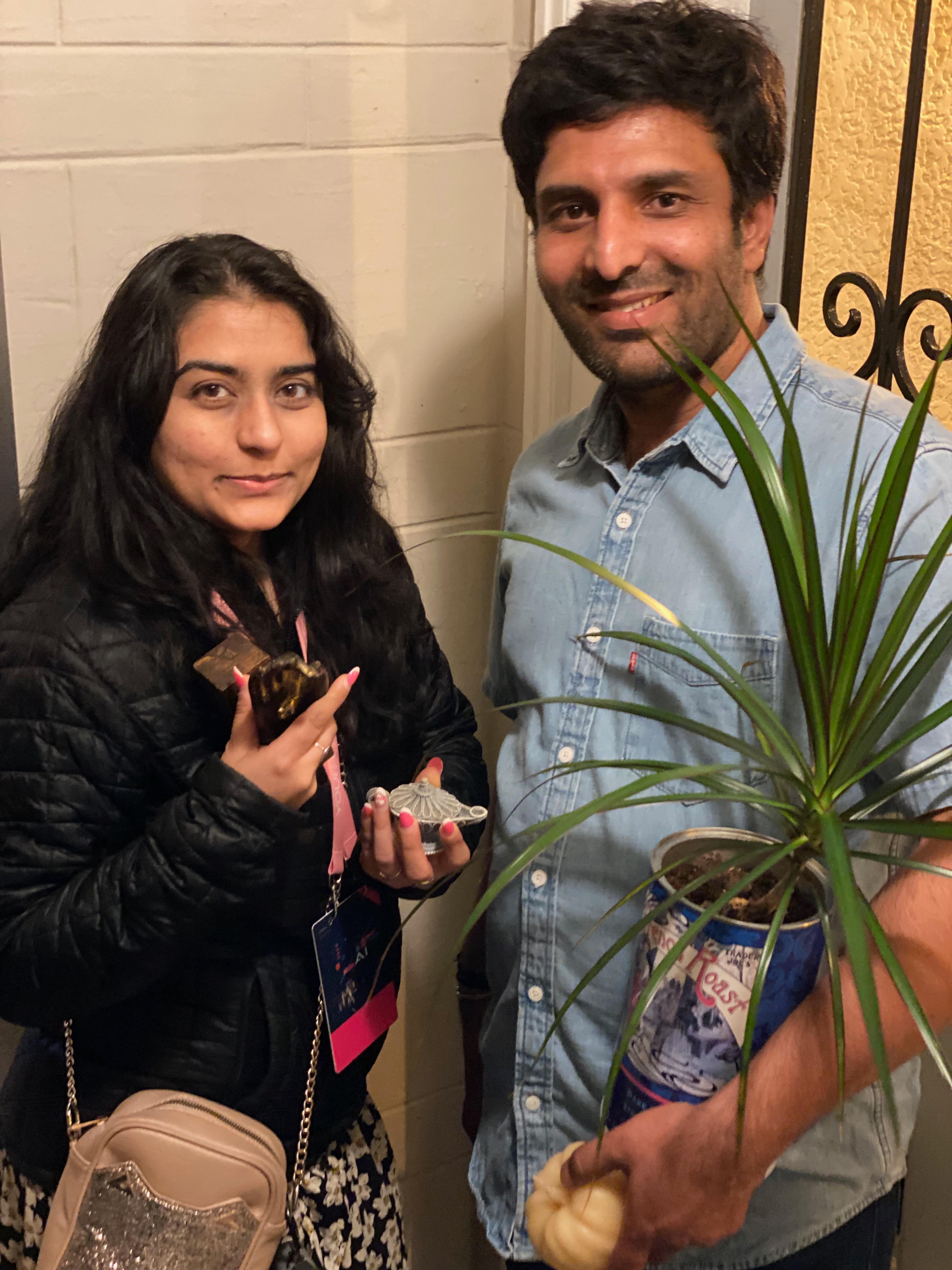 New plant parent smiling while holding a plant gifted by Reza Kaabi from Bank of Trees, ready to start their plant care journey.